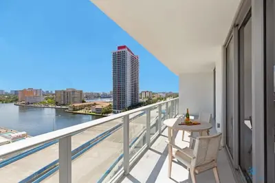 a balcony with a table and chairs and a view of the river at Beautiful apartment with Amazing Pool Balcony in Hollywood