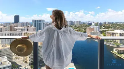 a woman standing on top of a building overlooking the city at Beautiful apartment with Amazing Pool Balcony in Hollywood