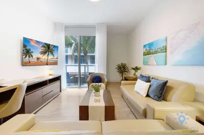 a living room with a couch and a table at Beautiful Apt 2BR Hollywood Beach Rooftop Pool in Hollywood