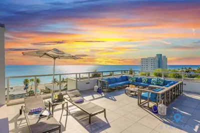 a balcony with a view of the beach and the ocean at Beautiful Apt 2BR Hollywood Beach Rooftop Pool in Hollywood