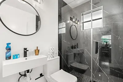 a bathroom with a sink toilet and a mirror at Farfalla XX in Miami
