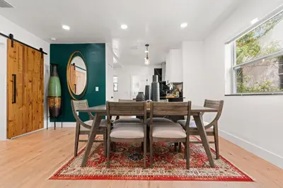 a dining room with a wooden table and chairs at Farfalla XX in Miami