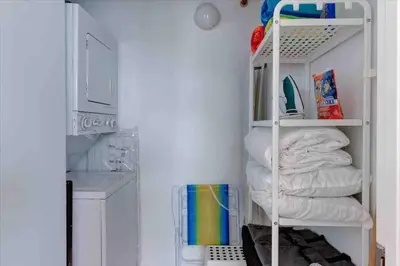 a room with a white shelf with towels at S BEACH SPOT Heated pool 2BLOCKs to BEACH BBQ in Miami Beach
