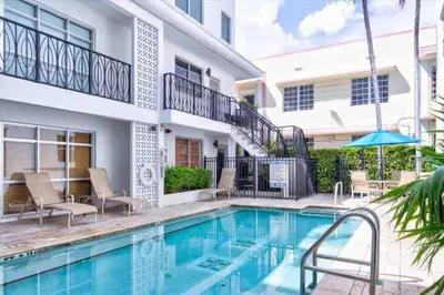 a swimming pool in front of a house at S BEACH SPOT Heated pool 2BLOCKs to BEACH BBQ in Miami Beach
