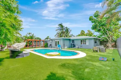 a backyard with a pool and a playground at Fort Lauderdale Tropical Oasis Pool Retreat in Fort Lauderdale