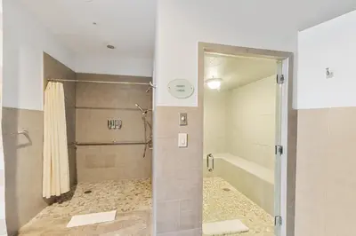 a shower with a glass door in a bathroom at Lujoso apartamento en playa de Sunny Isles Beach in Sunny Isles Beach