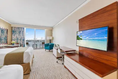 a hotel room with a bed and a flat screen tv at Lujoso apartamento en playa de Sunny Isles Beach in Sunny Isles Beach