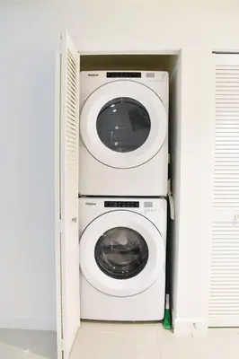 a washer and dryer in a white cabinet at Luxury apartment in Doral miami, 1 Bd in Miami
