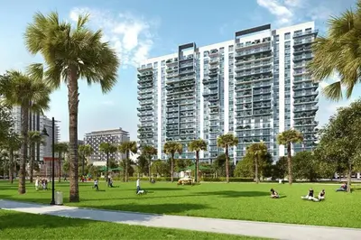 people in a park with palm trees and a large building at Comfortable Studio suites in downtown Doral in Miami