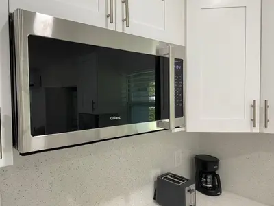 a microwave oven above a kitchen counter at Newly renovated studio close to the beach in Hollywood
