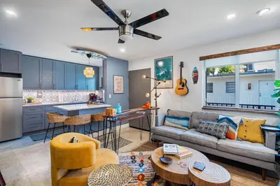 a living room with a couch and a kitchen at The SurfSide Hideout Charming Cozy Central in Miami