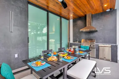 a dining room with a table with food on it at Carlotta- New Construction Luxury Waterfront Villa in Fort Lauderdale