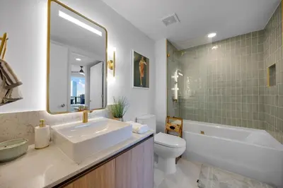 a bathroom with a sink and a tub and a toilet at Upscale 1-BD Condo with Stunning City Views in Miami