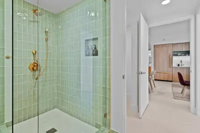 a bathroom with a shower with green tiles at Orange Crush - Resort-Style Amenities & Location in Miami