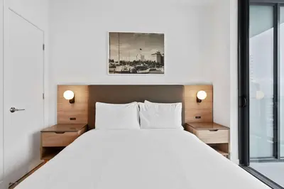 a bedroom with a large white bed with two lamps at Orange Crush - Resort-Style Amenities & Location in Miami