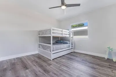a white bedroom with a bunk bed and a ceiling fan at Miami Modern Oasis Retreat - Close to Airport in Miami