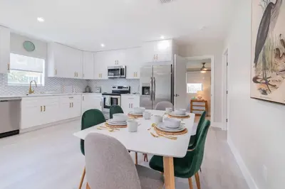 a kitchen and dining room with a white table and chairs at Executive Retreat Unit 1 - Fort Lauderdale in Fort Lauderdale