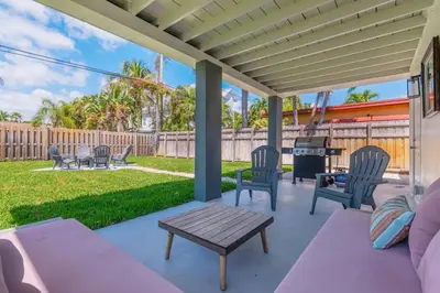 a patio with chairs and a table and a grill at Executive Retreat Unit 1 - Fort Lauderdale in Fort Lauderdale