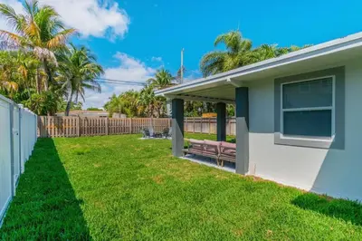 a house with a bench in a yard at Executive Retreat Unit 1 - Fort Lauderdale in Fort Lauderdale