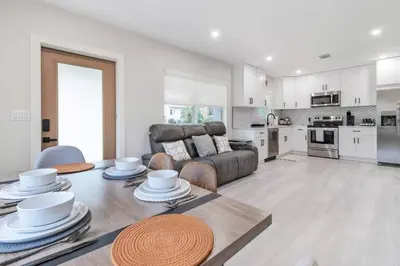 a living room with a table and a couch at Cozy Victoria Park Retreat Unit 3 - Las Olas Beach in Fort Lauderdale
