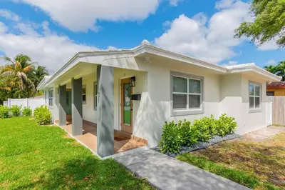 a house with a green lawn in front of it at Cozy Victoria Park Retreat Unit 3 - Las Olas Beach in Fort Lauderdale