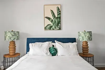 a bedroom with a bed with two lamps on it at Palms 811 in Miami Beach