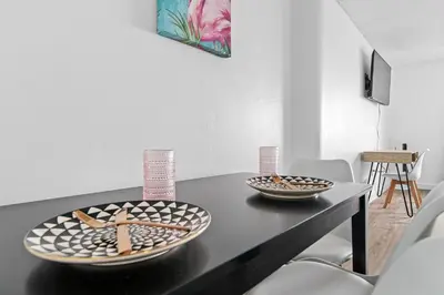 a black table with two plates on top of it at Palms 811 in Miami Beach