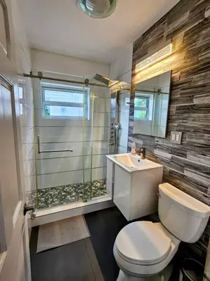 a bathroom with a shower and a toilet and a sink at Brickell Enclave Sunny Retreat with pool in Miami