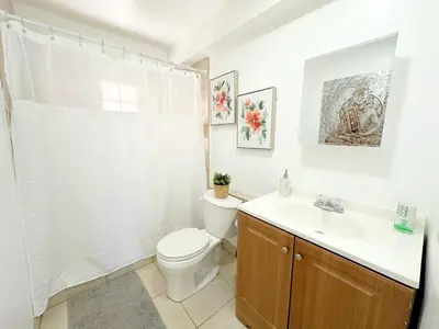 a bathroom with a toilet and a sink at Modern Miami Family Cottage Beach 15 min in Miami