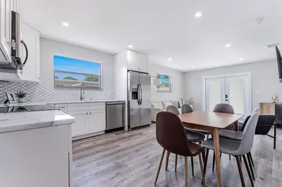a kitchen and dining room with a table and chairs at Modern Oasis Unit 2 - Close to Beach, Brickell & Airport in Miami