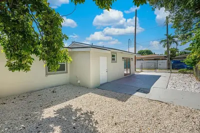 a house with a garage and a fence at Modern Oasis Unit 2 - Close to Beach, Brickell & Airport in Miami