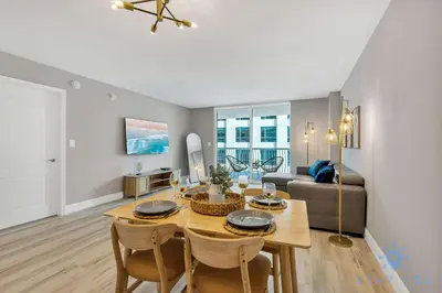 a living room with a table and a couch at Beautiful 1BR Apartment with Amenities in Miami