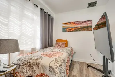 a small bedroom with a bed and a window at Hollywood Hideaway Close to Dtwn and Beaches in Hollywood