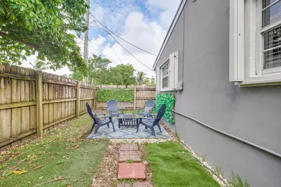 a patio with a table and chairs next to a fence at Hollywood Hideaway Close to Dtwn and Beaches in Hollywood