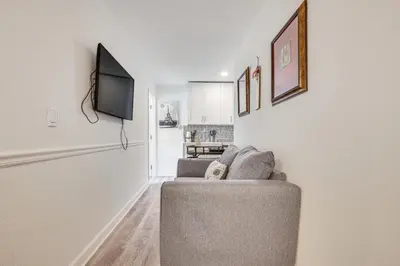 a living room with a couch and a flat screen tv at Hollywood Hideaway Close to Dtwn and Beaches in Hollywood
