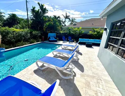 a group of lounge chairs next to a swimming pool at POOLSIDE MANOR - Men Only Clothing-Optional in Fort Lauderdale