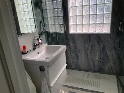 a bathroom with a sink and a mirror at POOLSIDE MANOR - Men Only Clothing-Optional in Fort Lauderdale