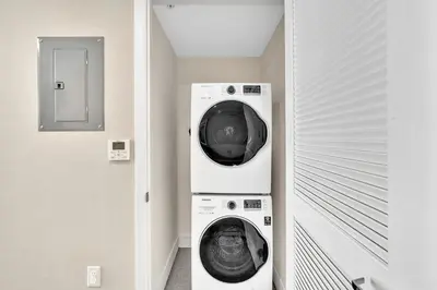 a laundry room with a washer and dryer at Grand Deluxe Two Bedroom Suite with Balcony Water Views, Corner in Miami Beach