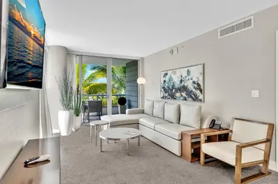 a living room with a couch and a table at Grand Deluxe Two Bedroom Suite with Balcony Water Views, Corner in Miami Beach
