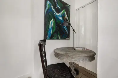 a room with a table with a lamp and a painting at Private Rooms at Miami, Buena Vista with Parking in Miami