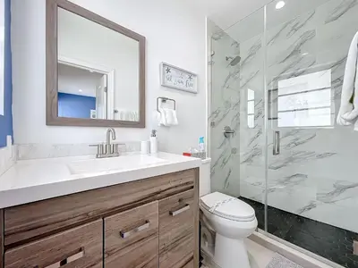 a bathroom with a toilet and a sink and a shower at Los Patios Home Suites in Miami Beach