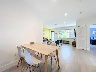 a dining room and living room with a table and chairs at Los Patios Home Suites in Miami Beach
