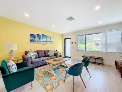 a living room with a couch and chairs at Los Patios Home Suites in Miami Beach