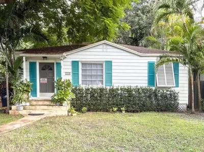 a blue and white house with a fence at Melrose Villa in Miami