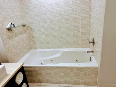 a bathroom with a white tub in a bathroom at Doral Pool 310 by WaveProperties in Miami