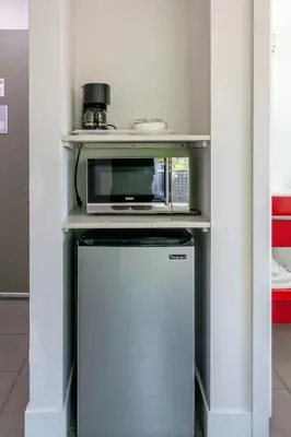 a microwave sitting on top of a small refrigerator at 7130 Costa Boutique in Miami Beach