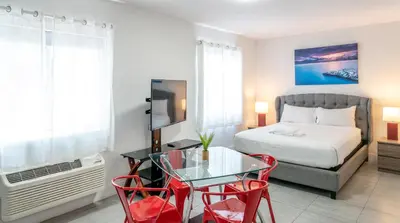 a bedroom with a bed and a table and chairs at 7130 Costa Boutique in Miami Beach