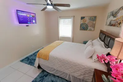 a bedroom with a bed and a ceiling fan at CasaBay 4 Bed 2 Bath House Ultimate Backyard Fun in Cutler Bay