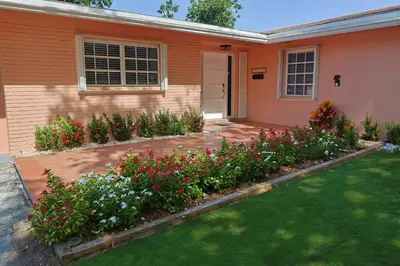 a house with flowers in the front yard at CasaBay 4 Bed 2 Bath House Ultimate Backyard Fun in Cutler Bay