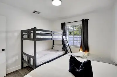 a bedroom with two bunk beds and a window at 8BR-4BA Spacious House, Sleeps 20, Pool, Fenced Yd in Miami